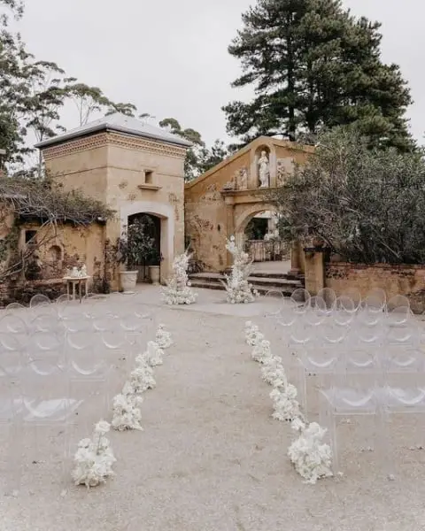 Monochromatic Aisle with Clear Chairs outdoor wedding aisle