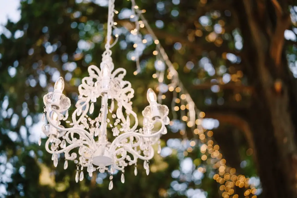 Chandeliers in trees wedding decor