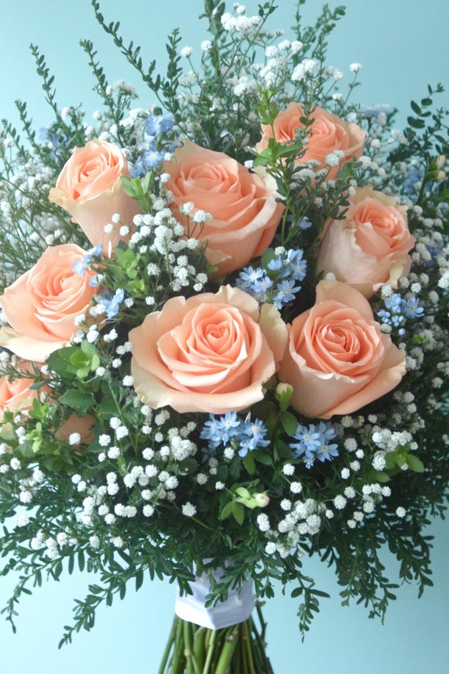 Peach roses with white and blue accents